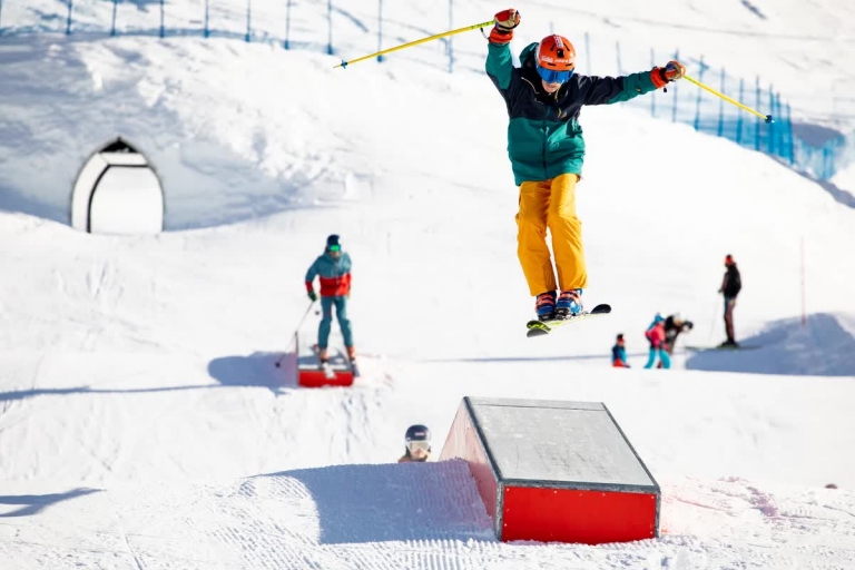Junger Skifahrer spring über Rampe